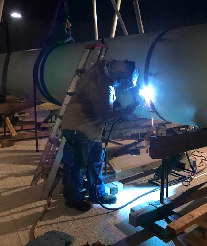 Night welding work on a large pipe section