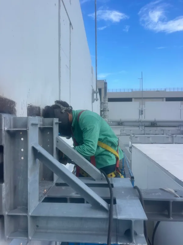Welder installing structural steel on site